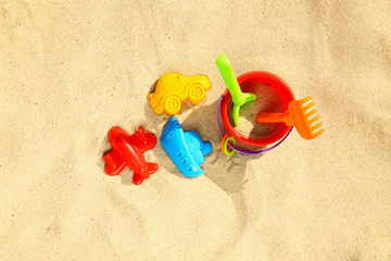 Fototapeta na wymiar Flat lay composition with plastic beach toys on sand