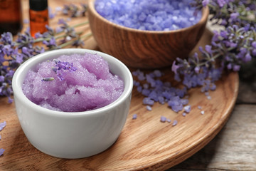Composition with natural sugar scrub and lavender flowers on wooden table. Cosmetic products