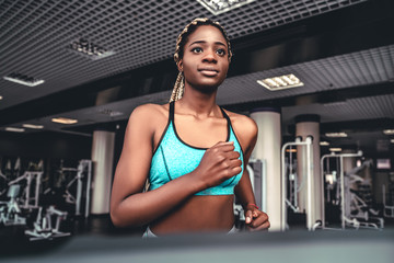 young woman exercise fitness and workout while run on track in sport club