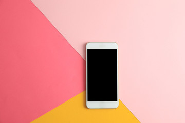 Modern phone on color background, top view. Space for text