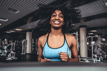 young woman exercise fitness and workout while run on track in sport club