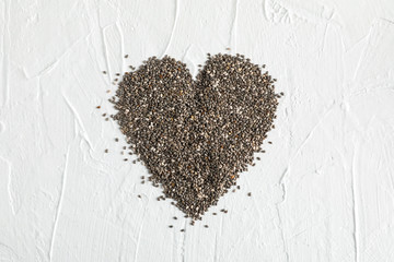 Heart layout of chia on white background, copy space