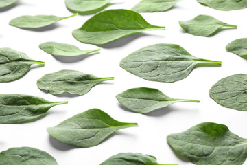Fresh green healthy spinach leaves on white background