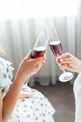 group of people touch champagne glasses and cocktails
