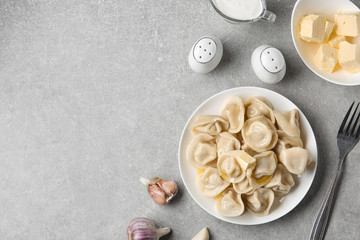 Flat lay composition with tasty dumplings on light grey table, space for text