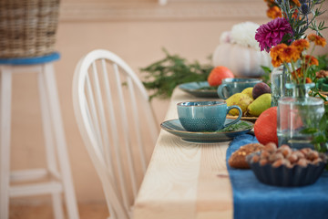 Festively served autumn table  with cup of tea on saucer