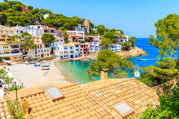 View of beach in Sa Tuna fishing village with colorful houses on shore, Costa Brava, Catalonia,...