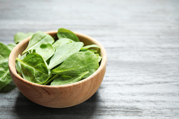 Fresh green healthy spinach on dark wooden table. Space for text