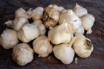 Group of garlic bulbs on a textured surface