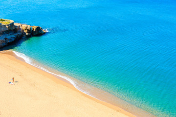 Unidentified young woman standing on Cala Moreta beach and looking at blue sea, Costa Brava, Catalonia, Spain