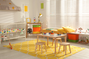 Cozy baby room interior with comfortable crib