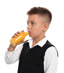 Fototapeta premium Little boy drinking juice on white background
