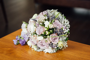 Wedding bouquet from beautiful flowers: pink roses, white and pink ranunculus
