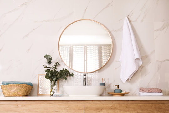 Stylish Bathroom Interior With Vessel Sink And Round Mirror