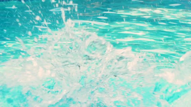 Boy jumps into a pool in slow motion