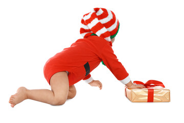 Festively dressed baby with gift box on white background. Christmas celebration