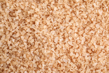 Brown sea salt as background, top view. Spa treatment