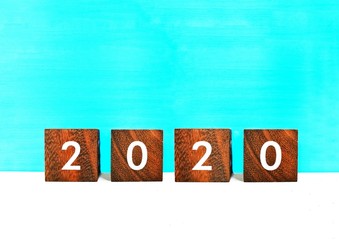 Wooden calendar on 2020 on a blue wooden background.New year concept.
