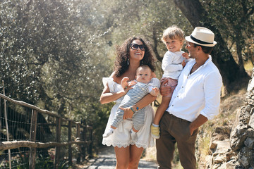 Young beautiful family walks in the Park in Italy