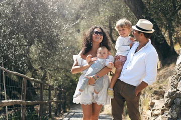 Papier Peint photo autocollant Ligurie Young beautiful family walks in the Park in Italy