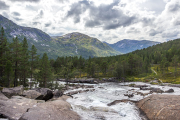 Fototapeta na wymiar Likholefossen waterfall and mountain river in Norway
