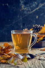 Hot blabck tea with spices on a wooden table,  rustic style, autumn postcard