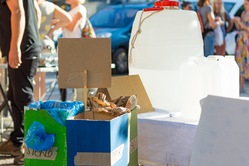 Improvised paper trash bins for recycling at outdoor event.