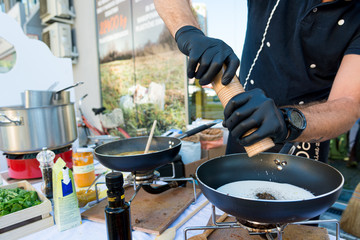 Chef preparing delicious organic pasta dish outdoor. Eating