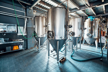 Naklejka na ściany i meble Fermentation mash vats or boiler tanks in a brewery factory