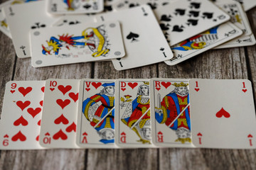 Combination of playing card on wooden background, royal flash