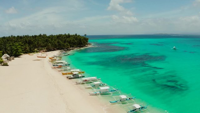 Seascape with a beautiful island. Daco island, Philippines. Tropical island with a white sandy beach for tourists. Island to relax.