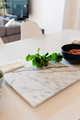 Marble cutting board in kitchen with ingredients 