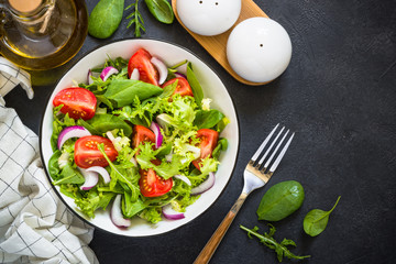 Green salad from leaves and tomatoes.