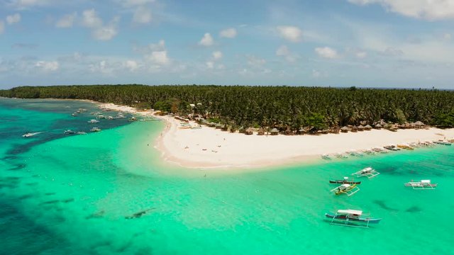Seascape with a beautiful island. Daco island, Philippines. Tropical island with a white sandy beach for tourists. Island to relax.