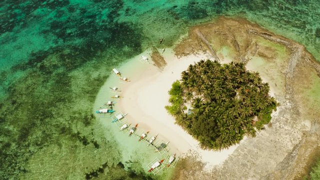 Guyam island, Siargao, Philippines. Small island with palm trees and a white sandy beach. Philippine Islands.