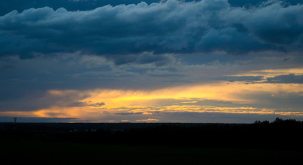 View to the sunset sky with yellow clouds.