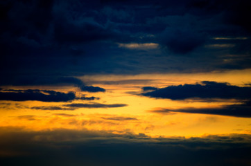 Fototapeta na wymiar View to the sunset sky. Black and orange clouds. 