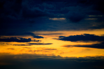 View to the sunset sky. Black and orange clouds.   