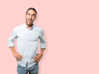 Fototapeta premium Surprised young man making a gesture of doubt