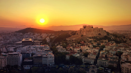 Aerial photo of iconic Masterpiece of Ancient world, Acropolis and the Parthenon at sunset with beautiful golden colours, Athens, Attica, Greece
