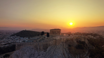 Aerial photo of iconic Masterpiece of Ancient world, Acropolis and the Parthenon at sunset with beautiful golden colours, Athens, Attica, Greece