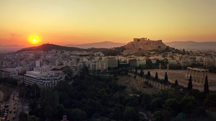 Aerial photo of iconic Masterpiece of Ancient world, Acropolis and the Parthenon at sunset with beautiful golden colours, Athens, Attica, Greece