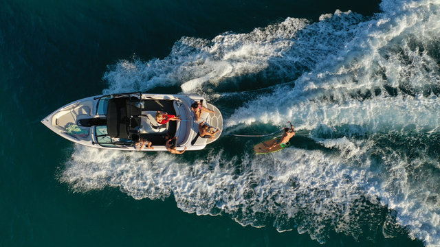 Aerial Photo Of Woman Practising Waterski In Mediterranean Bay With Emerald Sea At Sunset