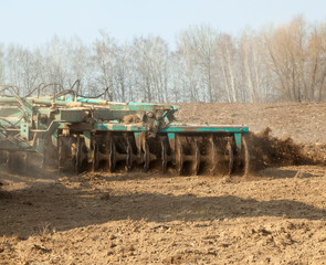Obraz premium Harrowing the soil with disc harrows