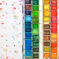 watercolor paints in a box, artistic materials often used in drops of cracks