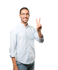Fototapeta premium Young man making a number two gesture