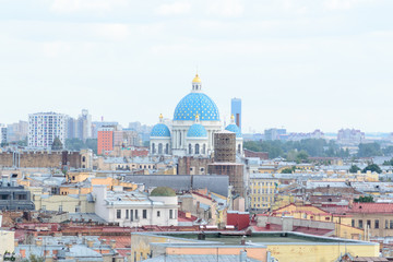 Fototapeta na wymiar Cityscape view of the city of Saint Petersburg, Russia. in the midst of many roofs emerge the colorful blue domes of the famous Trinity Cathedral