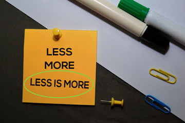 Less is More on sticky notes isolated on black white background