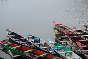 colorful row boats waiting at Dawki river shore