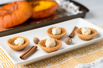 Pumpkin spice butter tart. Mini sugar pies (or butter tarts) with a crisp pastry crust, a sweet filling and pumpkin spice whipped cream on top. A tasty dessert for fall holidays like halloween!